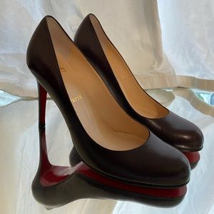 A pair of christian louboutin pumps